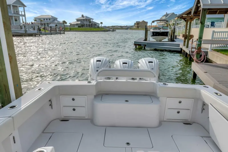 Aqua Toy Yacht Photos Pics 2023 Jupiter 43 Center Console boat docked in a scenic waterfront setting.