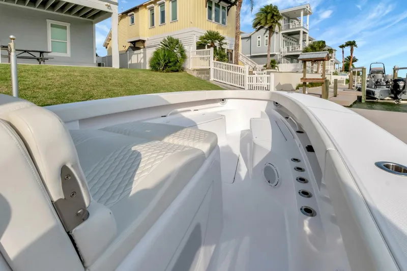 Aqua Toy Yacht Photos Pics 2023 Jupiter 43 Center Console boat docked near modern waterfront homes.