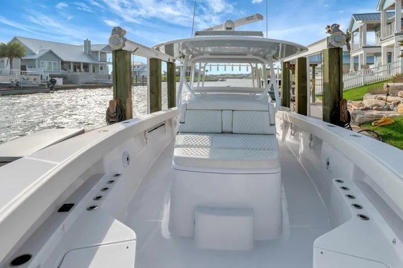 Aqua Toy Yacht Photos Pics 2023 Jupiter 43 Center Console boat docked, showcasing sleek design and spacious seating.