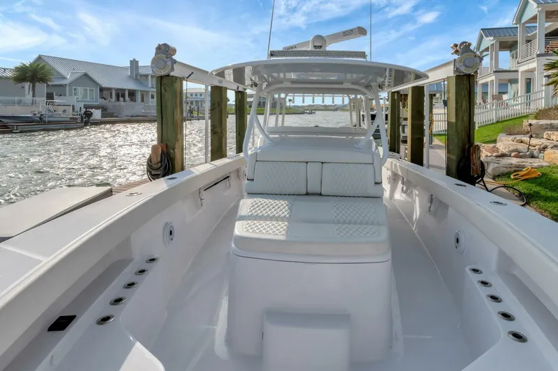 Aqua Toy Yacht Photos Pics 2023 Jupiter 43 Center Console boat docked by waterfront homes.
