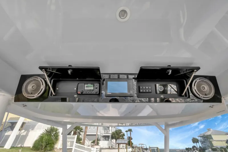 Aqua Toy Yacht Photos Pics 2023 Jupiter 43 Center Console dashboard with speakers and electronic controls.