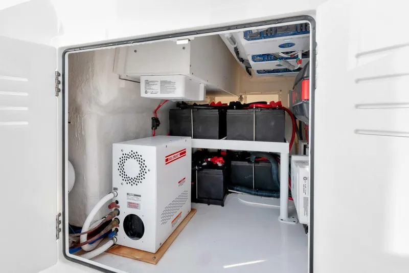 Aqua Toy Yacht Photos Pics Interior view of 2023 Jupiter 43 Center Console's electrical compartment with batteries and equipment.