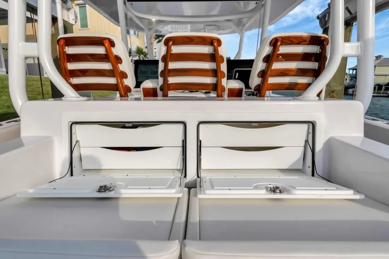 Aqua Toy Yacht Photos Pics 2023 Jupiter 43 Center Console boat interior with wooden seats and storage compartments.
