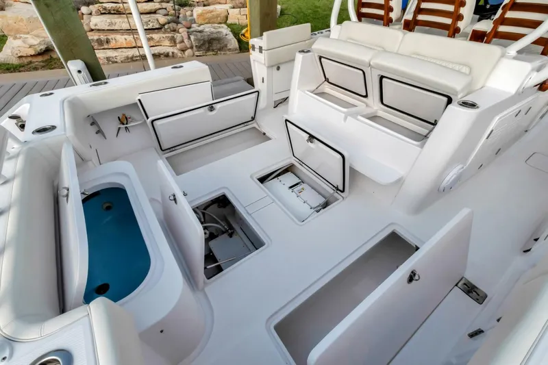Aqua Toy Yacht Photos Pics 2023 Jupiter 43 Center Console boat interior with open storage compartments and seating.