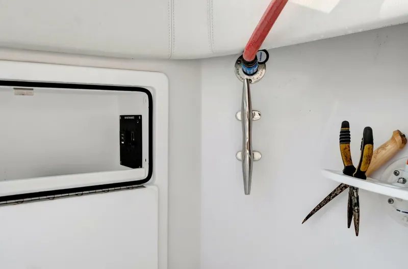 Aqua Toy Yacht Photos Pics Interior view of 2023 Jupiter 43 Center Console boat with tools and storage compartment.