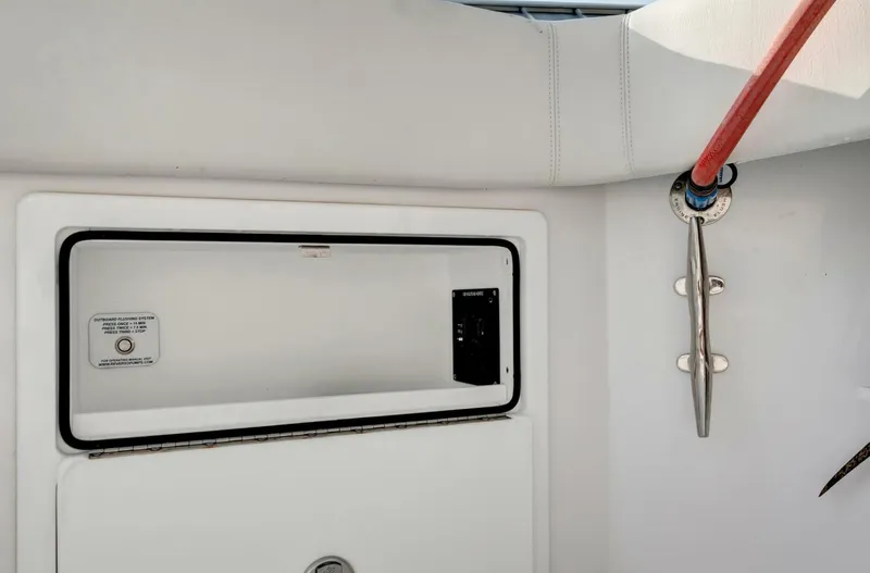 Aqua Toy Yacht Photos Pics Interior detail of 2023 Jupiter 43 Center Console boat, featuring storage compartment and cleat.