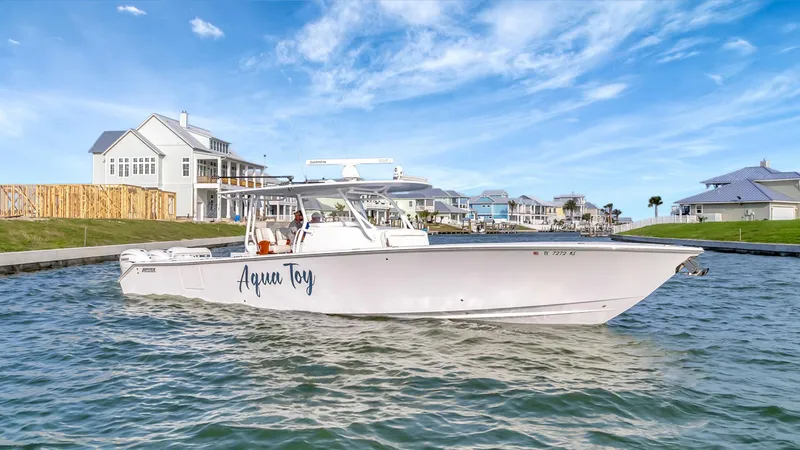 Aqua Toy Yacht Photos Pics 2023 Jupiter 43 Center Console boat on water near coastal homes.