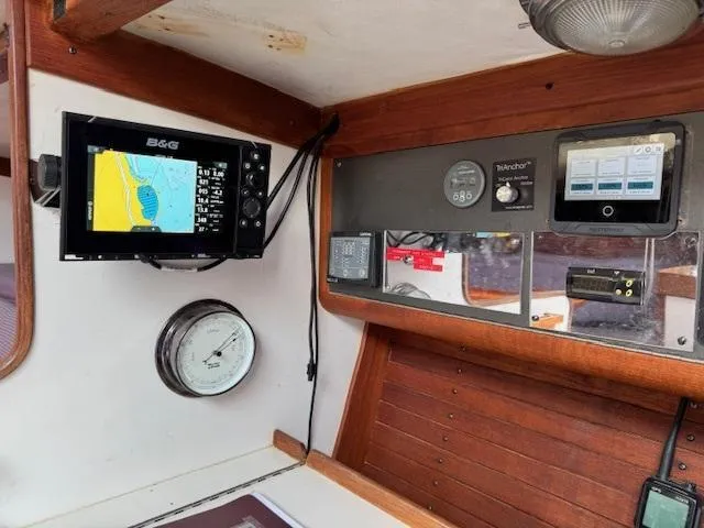  Yacht Photos Pics Interior of 1996 J Boats J/120 with navigation equipment and wooden paneling.