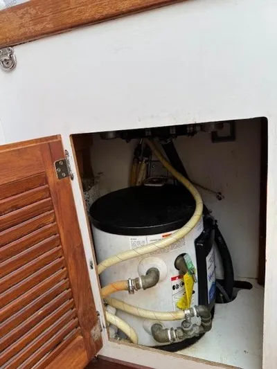  Yacht Photos Pics 1996 J Boats J/120 interior compartment with water heater and hoses.