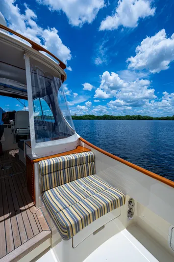 Norora Yacht Photos Pics 2016 Hinckley Picnic Boat 37 MKIII on serene water under a vibrant blue sky.