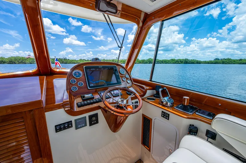 Norora Yacht Photos Pics 2016 Hinckley Picnic Boat 37 MKIII helm with wooden dashboard and scenic water view.