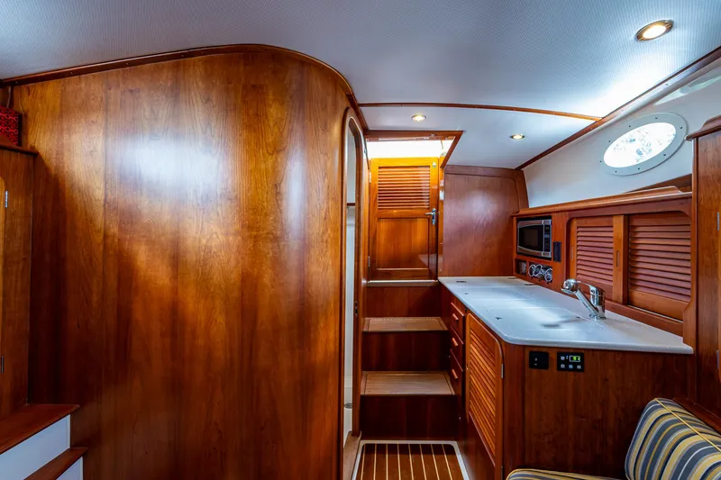 Norora Yacht Photos Pics Interior of 2016 Hinckley Picnic Boat 37 MKIII with wooden cabinetry and modern amenities.