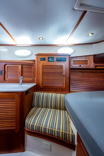 Norora Yacht Photos Pics Interior of 2016 Hinckley Picnic Boat 37 MKIII with wood cabinetry and striped seating.