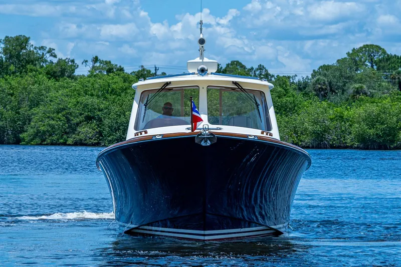 Norora Yacht Photos Pics 2016 Hinckley Picnic Boat 37 MKIII cruising on a serene lake.