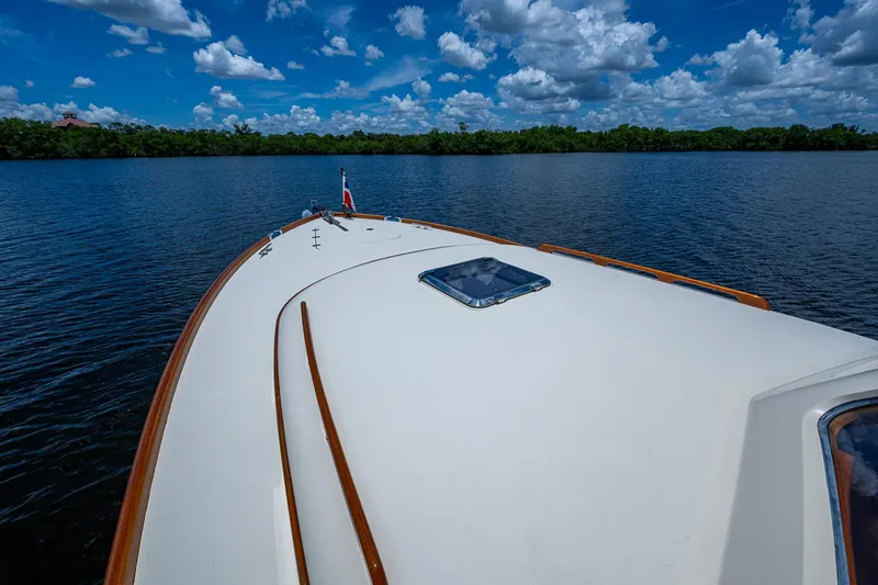 Norora Yacht Photos Pics 2016 Hinckley Picnic Boat 37 MKIII cruising on a serene lake under a blue sky.