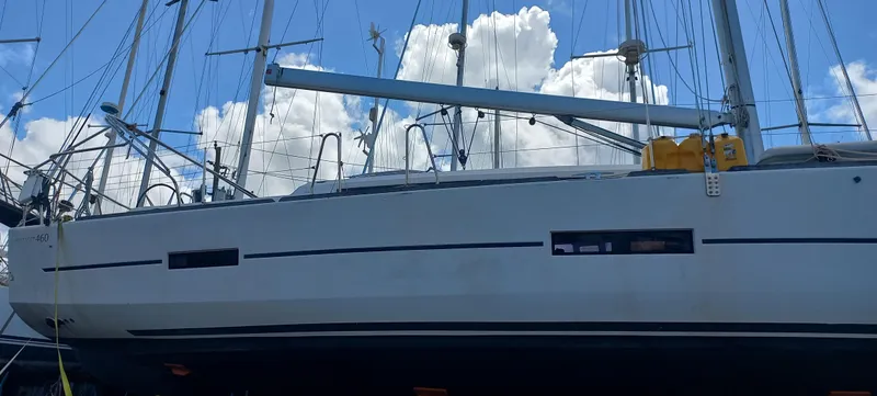 Pelican Yacht Photos Pics Dufour 460 Grand Large 2020 sailboat docked under a blue sky with clouds.