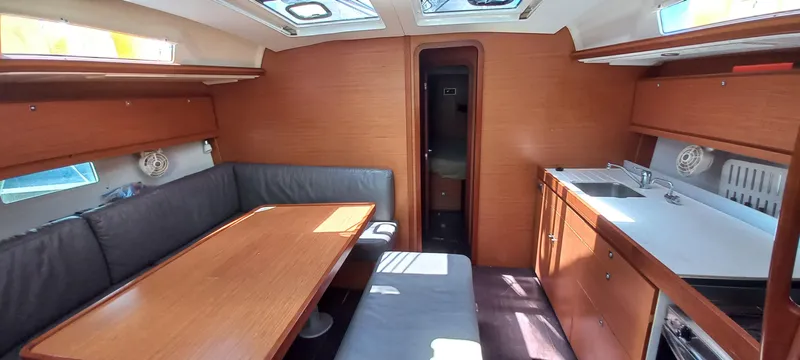 Pelican Yacht Photos Pics Interior of 2020 Dufour 460 Grand Large yacht with dining area and kitchenette.