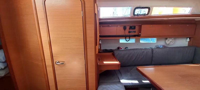Pelican Yacht Photos Pics Interior of 2020 Dufour 460 Grand Large yacht with wooden finish and seating area.