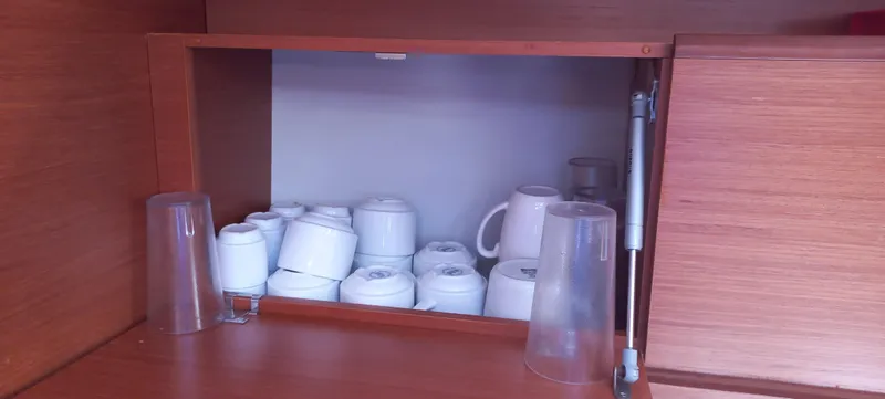 Pelican Yacht Photos Pics Cupboard with stacked cups and glasses on a Dufour 460 Grand Large yacht, 2020 model.