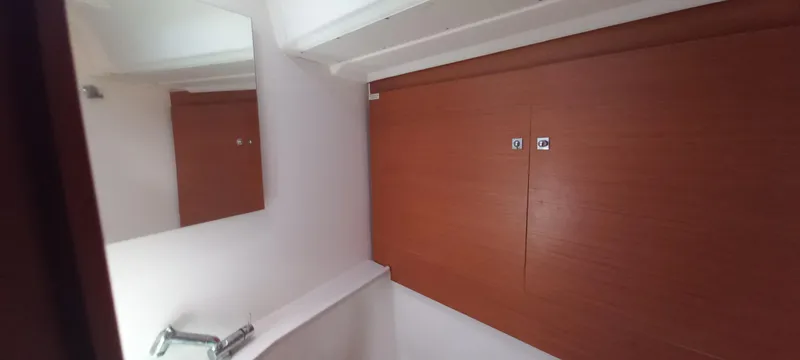 Pelican Yacht Photos Pics Interior of 2020 Dufour 460 Grand Large yacht, featuring wooden cabinetry and a mirror.