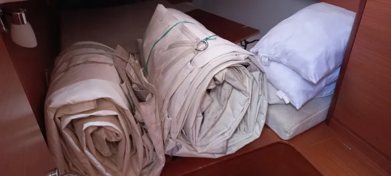 Pelican Yacht Photos Pics Rolled sails and cushions in a Dufour 460 Grand Large, 2020 model, cabin storage area.