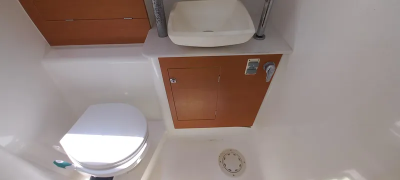 Pelican Yacht Photos Pics Bathroom interior of 2020 Dufour 460 Grand Large yacht, featuring sink and toilet.