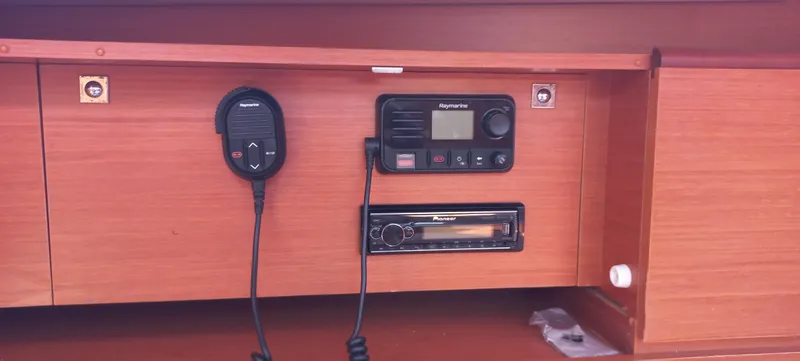 Pelican Yacht Photos Pics 2020 Dufour 460 Grand Large yacht radio and control panel in wooden cabinet.