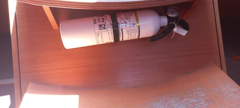 Pelican Yacht Photos Pics Fire extinguisher in wooden compartment of 2020 Dufour 460 Grand Large yacht.