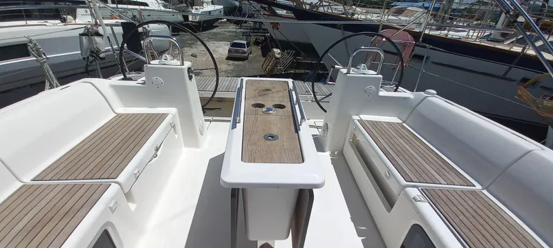 Pelican Yacht Photos Pics Dufour 460 Grand Large 2020 yacht cockpit with dual steering wheels and teak seating.