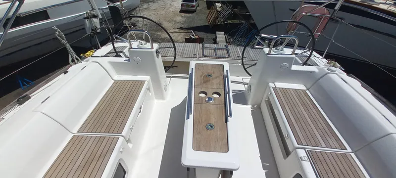 Pelican Yacht Photos Pics 2020 Dufour 460 Grand Large yacht cockpit with dual steering wheels and wooden seating.