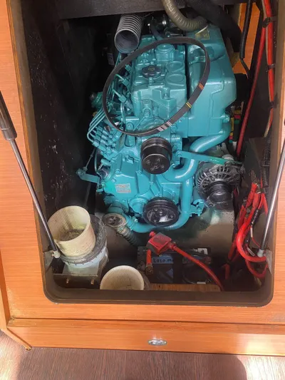 Pelican Yacht Photos Pics Engine compartment of a 2020 Dufour 460 Grand Large sailboat, featuring a blue marine engine.