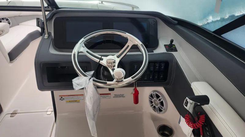  Yacht Photos Pics 2025 Regal LX6 boat dashboard with steering wheel and control panel.