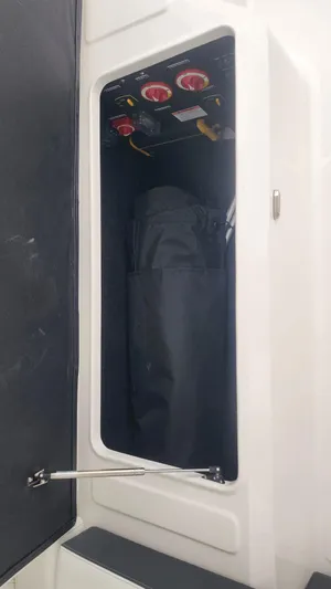  Yacht Photos Pics 2025 Regal LX6 storage compartment with electrical panel and switches.