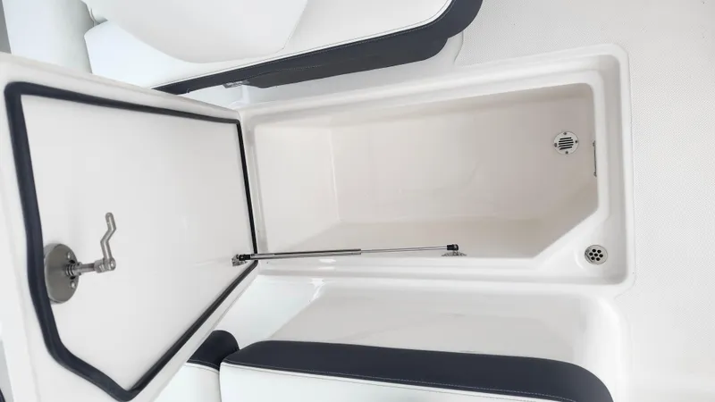  Yacht Photos Pics 2025 Regal LX6 boat storage compartment with open lid, showcasing spacious interior design.