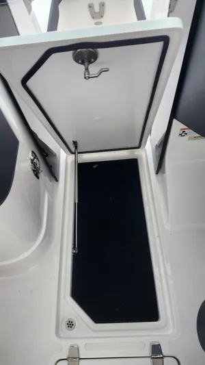  Yacht Photos Pics 2025 Regal LX6 boat storage compartment with open hatch and sleek design.