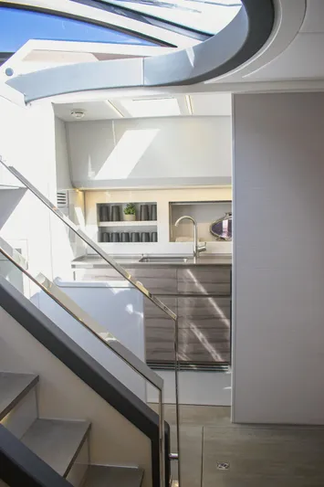 Finstar Yacht Photos Pics Modern kitchen interior on a 2014 Pershing 62 yacht, featuring sleek cabinetry and natural lighting.