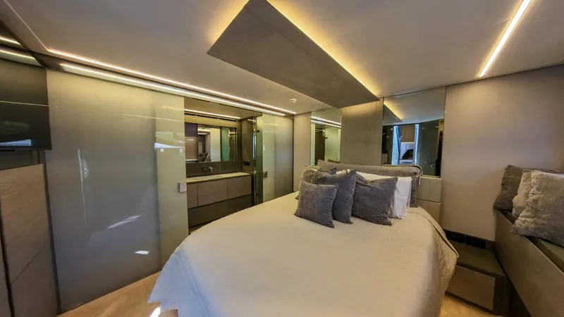 Finstar Yacht Photos Pics Luxurious bedroom interior of 2014 Pershing 62 yacht with modern design and ambient lighting.