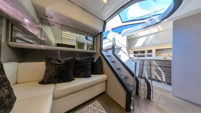 Finstar Yacht Photos Pics Luxurious interior of a 2014 Pershing 62 yacht with modern seating and skylight.