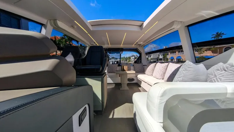 Finstar Yacht Photos Pics Luxurious interior of a 2014 Pershing 62 yacht with modern seating and panoramic windows.