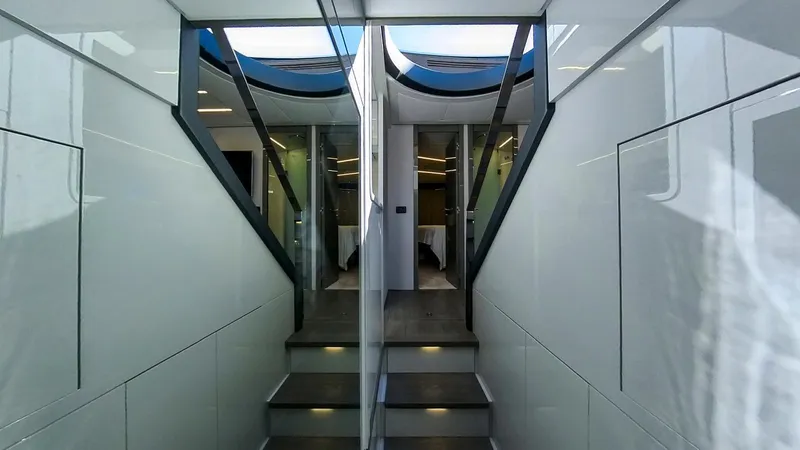 Finstar Yacht Photos Pics Interior of 2014 Pershing 62 yacht, featuring sleek modern design and illuminated stairs.