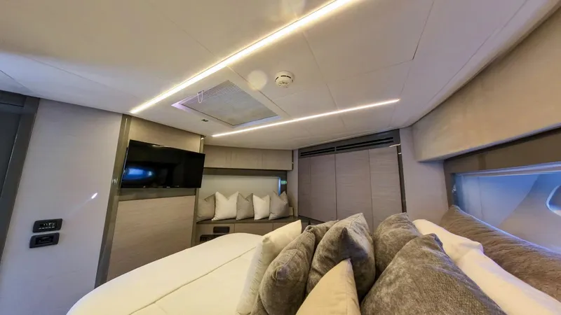 Finstar Yacht Photos Pics Luxurious interior of a 2014 Pershing 62 yacht with modern design and cozy bedding.