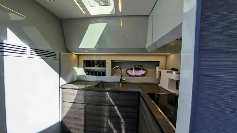 Finstar Yacht Photos Pics Modern kitchen interior of 2014 Pershing 62 yacht with sleek design and ample lighting.