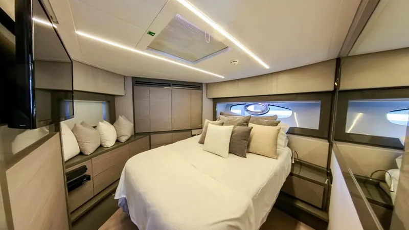 Finstar Yacht Photos Pics Luxurious bedroom interior of 2014 Pershing 62 yacht with modern design and cozy bedding.