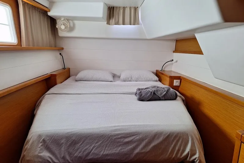 Kala Yacht Photos Pics Cozy cabin interior of 2016 Lagoon 450 F catamaran with double bed and wooden accents.