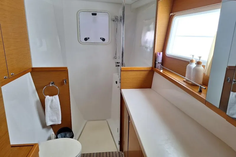 Kala Yacht Photos Pics Luxurious bathroom interior of 2016 Lagoon 450 F catamaran, featuring modern fixtures and ample natural light.