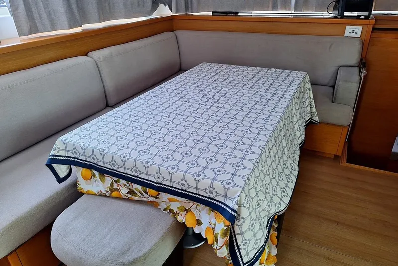 Kala Yacht Photos Pics Interior of 2016 Lagoon 450 F yacht with a patterned tablecloth on a dining table.