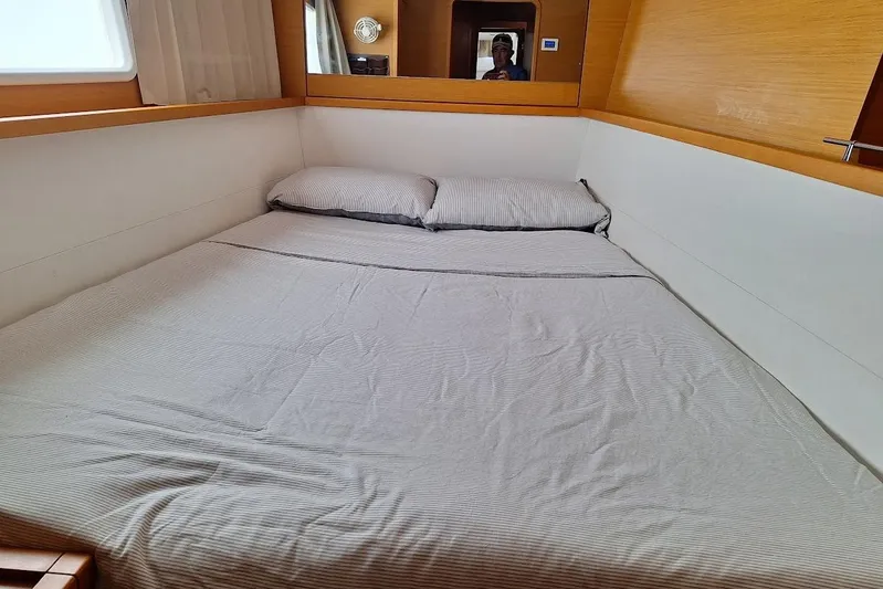 Kala Yacht Photos Pics Cozy cabin bedroom in 2016 Lagoon 450 F yacht with striped bedding.