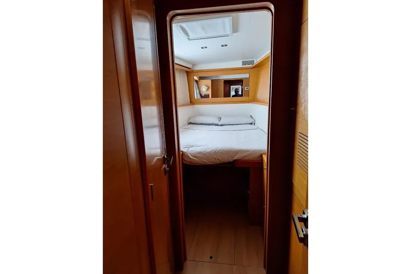 Kala Yacht Photos Pics Cabin interior of 2016 Lagoon 450 F yacht, featuring a cozy bed and wooden finish.