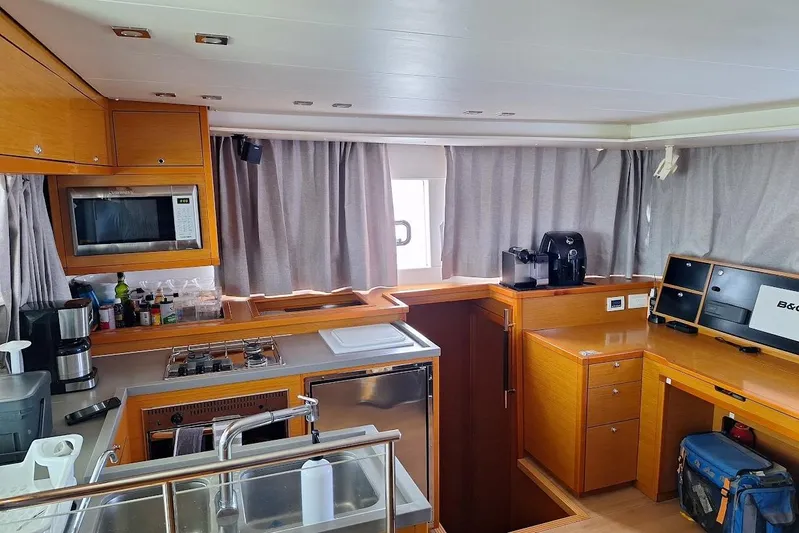 Kala Yacht Photos Pics Interior of 2016 Lagoon 450 F catamaran kitchen with modern appliances and wooden cabinetry.