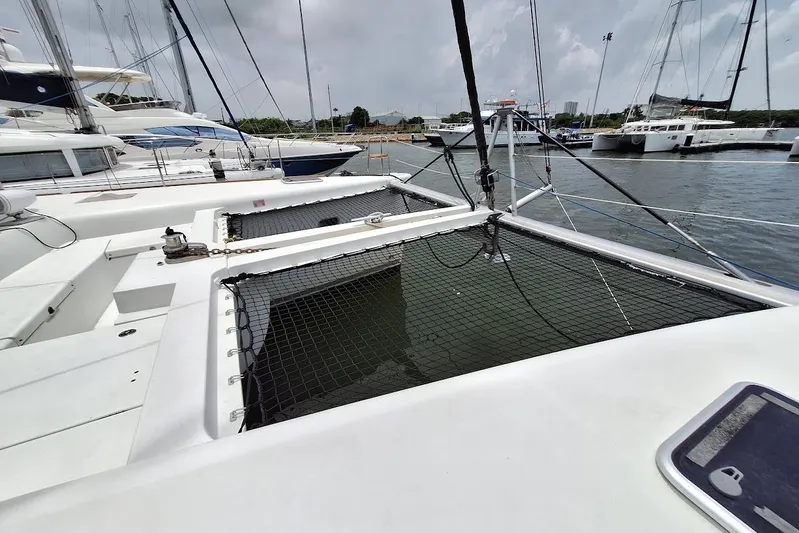 Kala Yacht Photos Pics Lagoon 450 F catamaran, 2016 model, docked at marina with netted deck area.